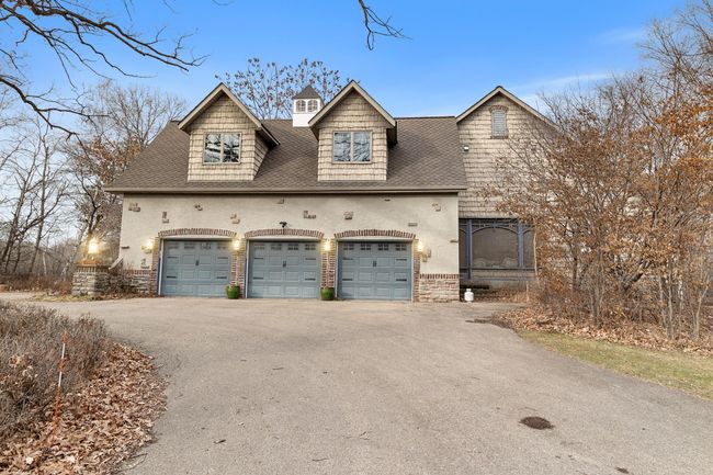 Three stalls in the attached garage are heated and directly access the main hallway of the house near the laundry room and kitchen. Screened-in porch is shown on the right. | Image 75