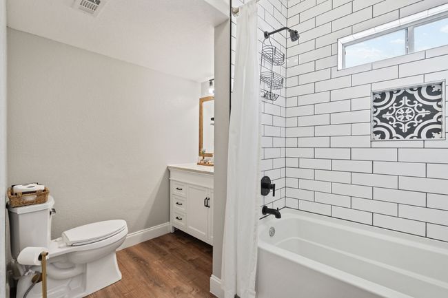 Primary bathroom with vaulted ceilings and decorative soap dish tile work | Image 10
