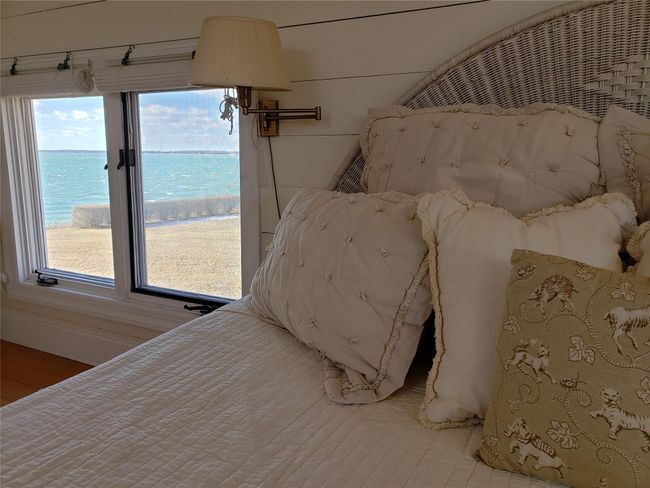 Shiplap walled bedroom featuring a water view also gets sunsets | Image 34