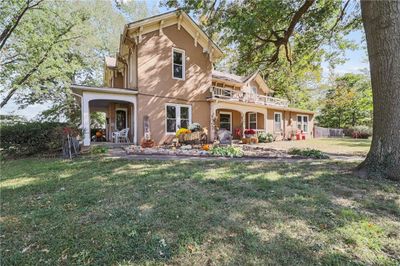 View of front of house with a balcony, a front lawn, and covered porch | Image 3