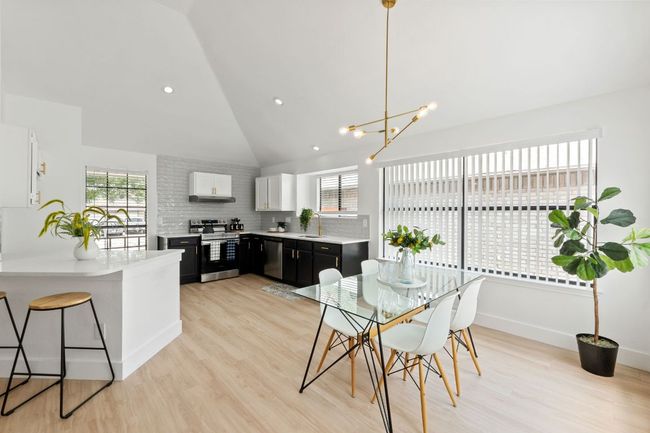 Dining space with a healthy amount of sunlight, and high vaulted ceiling | Image 10