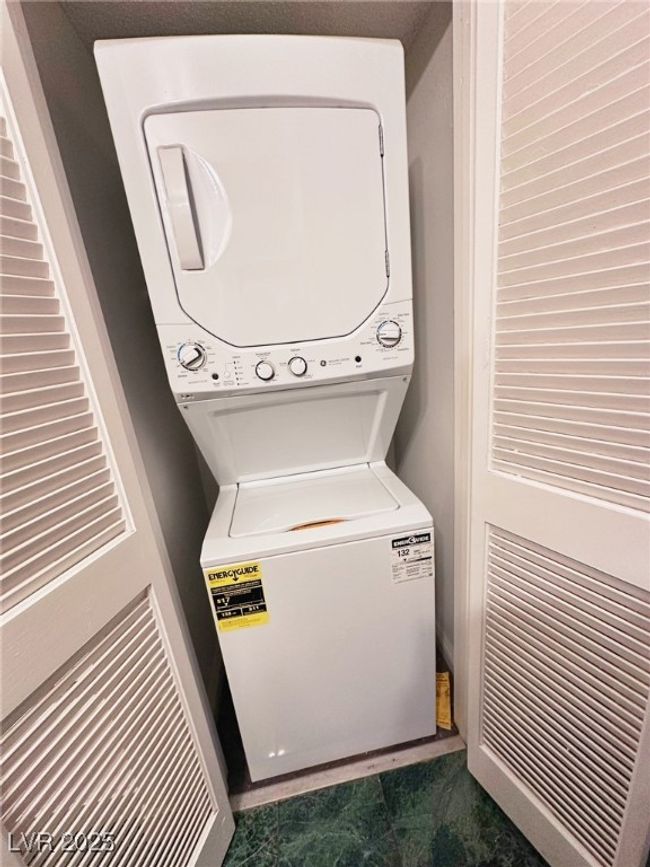 Laundry room featuring stacked washing machine and dryer | Image 10