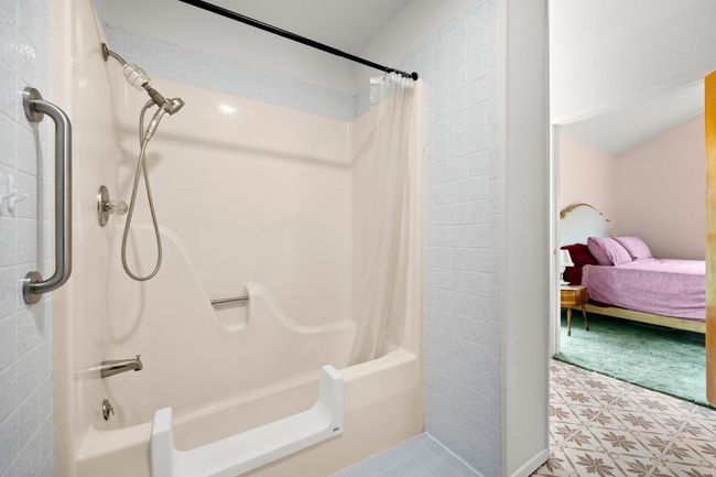 Full bath with shower / bath combo and tile patterned floors | Image 19