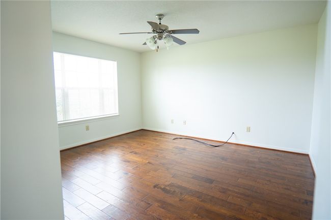 Unfurnished room with ceiling fan and wood-type flooring | Image 19
