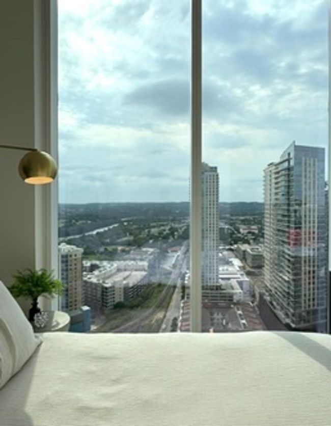 Bedroom featuring a city view | Image 4