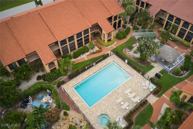 Aerial view of property and surrounding area featuring a pool area | Image 36