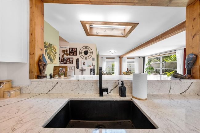 Main Home - This large farmhouse sink makes it easy for clean up and over looks the counter with the barstools. | Image 22