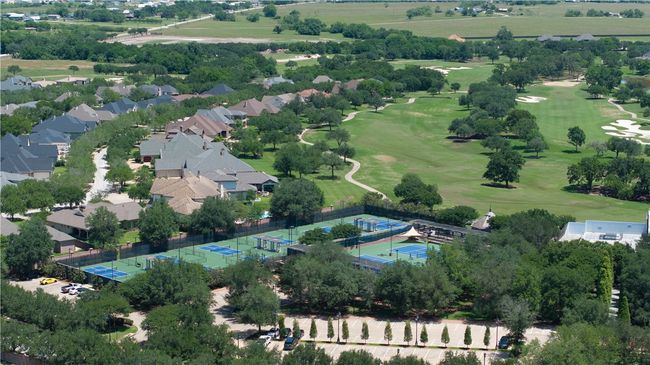 Drone / aerial view of a golf course and a tree filled landscape | Image 37