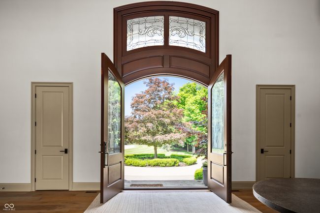 entrance foyer with french doors, a high ceiling and wood finished floors | Image 5
