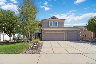 This amazing home features a 3 car garage, mature landscaping and a concrete tile roof. | Image 1