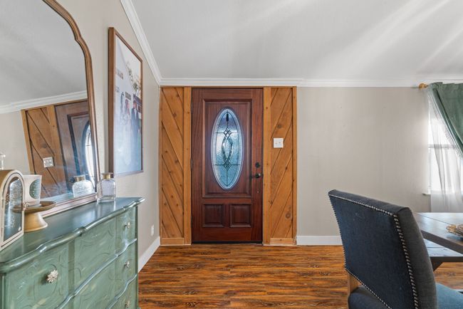 Entrance foyer with crown molding, dark wood finished floors, and plenty of natural light | Image 5