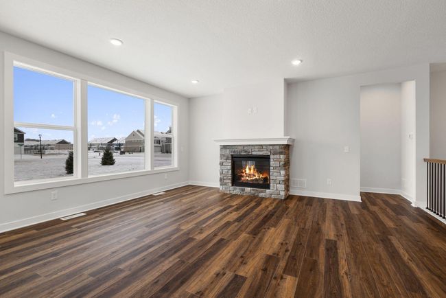 This cozy living space is anchored by a beautiful fireplace, adding both warmth and charm to the room. Perfect for relaxing on cooler evenings or creating a focal point for gatherings, the fireplace enhances the inviting ambiance of the space. | Image 8