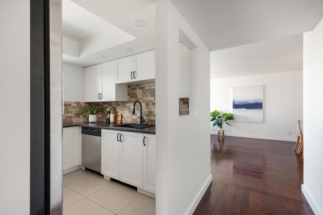 Bar area featuring dishwasher, decorative backsplash, and light wood-style flooring | Image 18