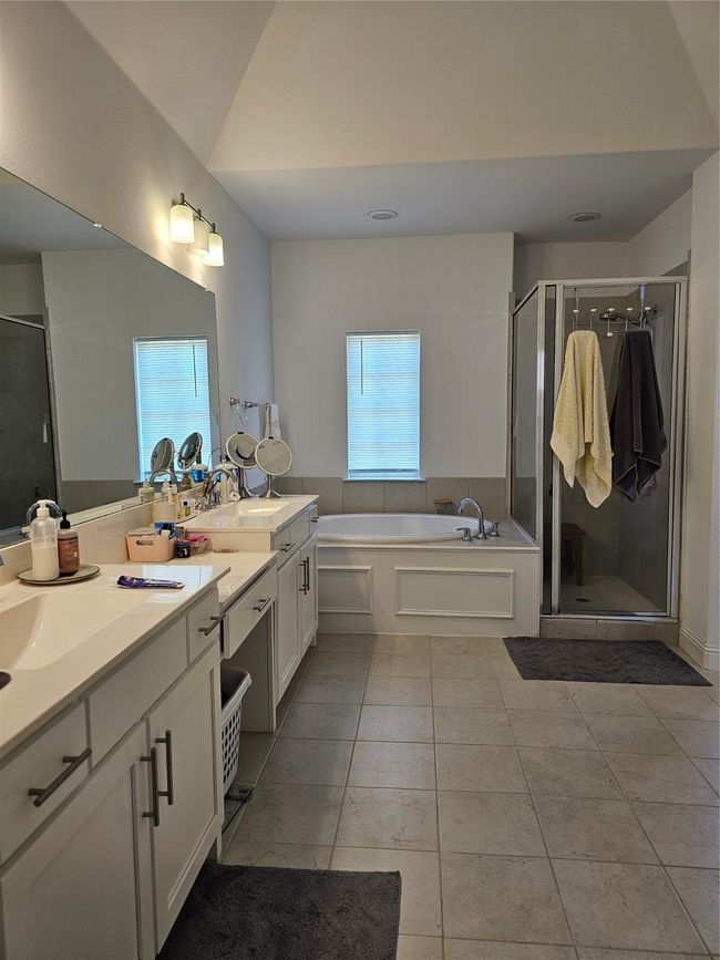 Full bath with vanity, a garden tub, a shower stall, and tile patterned floors | Image 4
