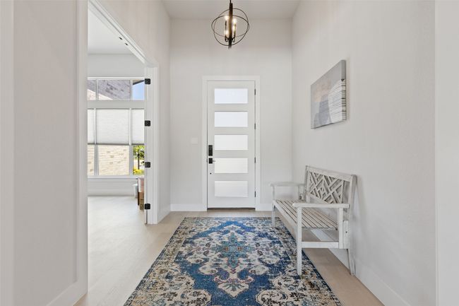 Entrance foyer featuring baseboards, a chandelier, and light wood finished floors | Image 7