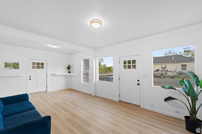 Foyer entrance with baseboards and light wood-style flooring | Image 9