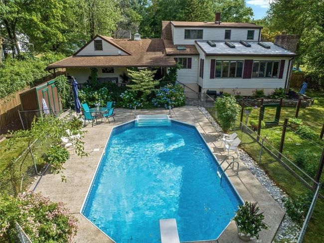 View of pool featuring a diving board and a patio area | Image 28