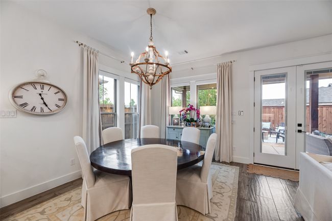 Dining area with a chandelier, plenty of natural light, light wood-style floors, and french doors | Image 10