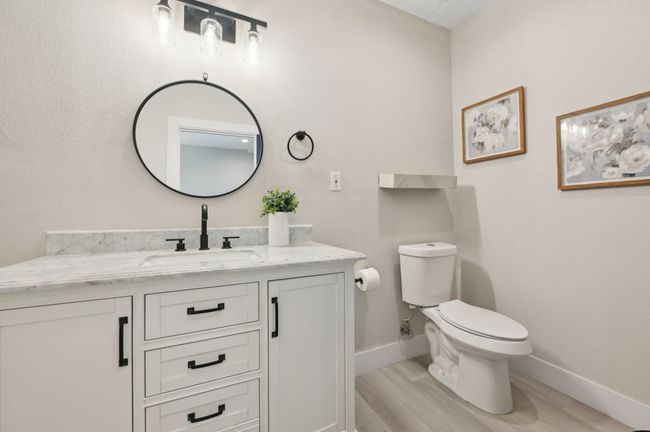 Half bath featuring wood finished floors, vanity, baseboards, and toilet | Image 26