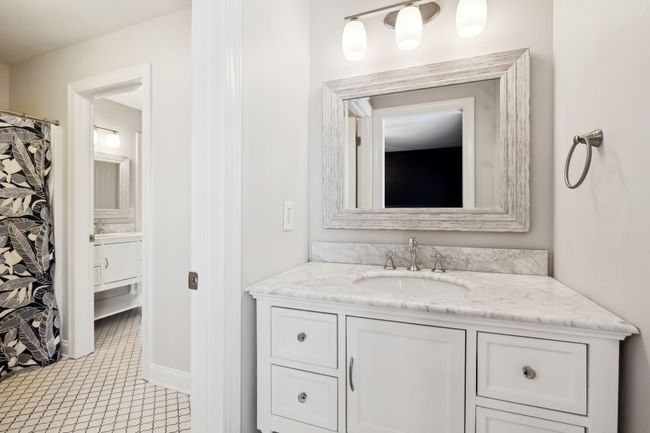 Well-appointed Jack-and-Jill bathroom with marble vanity and separate bath/shower area. | Image 28