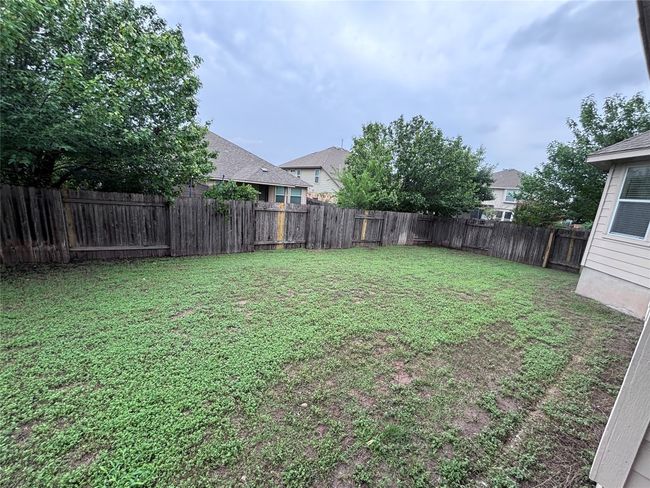 View of fenced backyard | Image 19