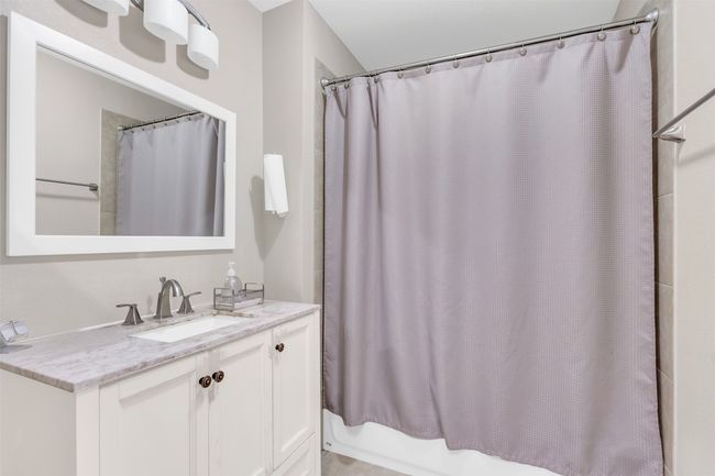 Full bathroom featuring vanity and shower / tub combo with curtain | Image 13