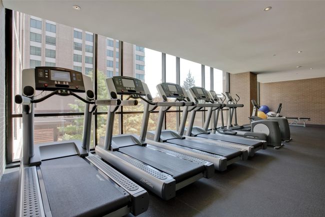 Work-out in the light-filled, spacious and well- equipped Gym/Fitness center overlooking pool and courtyard with trees and greenery. | Image 37