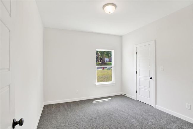 Spare room with baseboards and carpet | Image 18