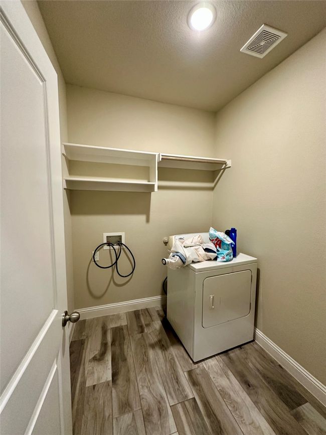 Washroom featuring washer / clothes dryer, wood finished floors, and a textured ceiling | Image 21