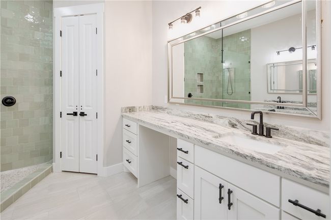 Full bathroom featuring vanity, walk in shower, a closet, and tile patterned floors | Image 13