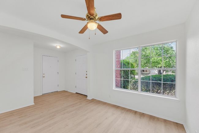 Spare room featuring light wood-type flooring, a ceiling fan, and baseboards | Image 22