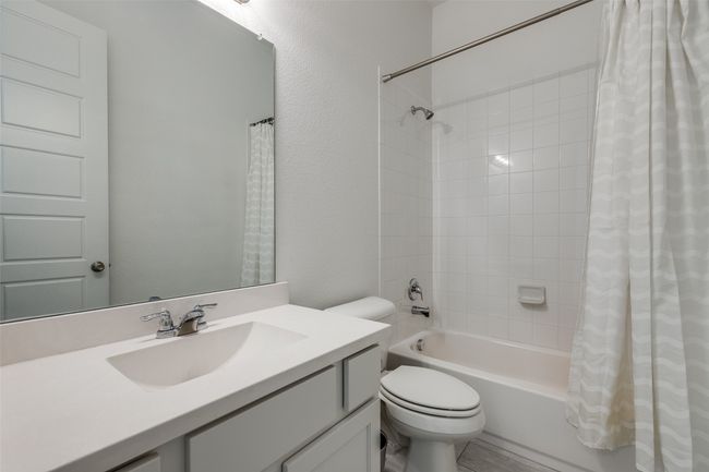 Full bath with toilet, vanity, and shower / bathtub combination with curtain | Image 22