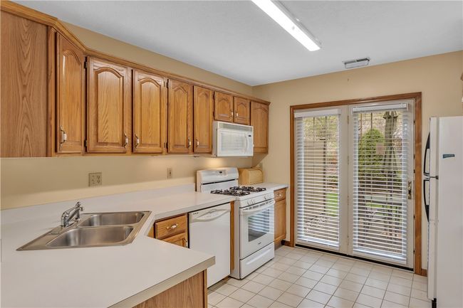 11x9 Kitchen with Neutral Laminate Counters, Tile Floor and Oak Finish Cabinets. | Image 12
