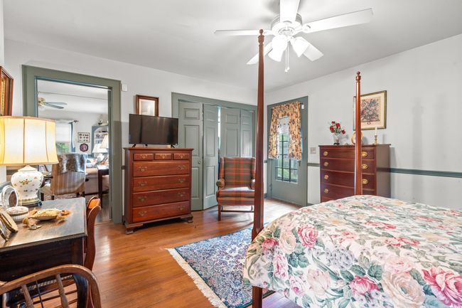 Bedroom with light wood finished floors, a closet, and ceiling fan | Image 14