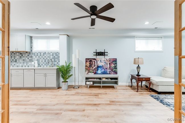Sitting room featuring a ceiling fan, plenty of natural light, and light wood-style floors | Image 22