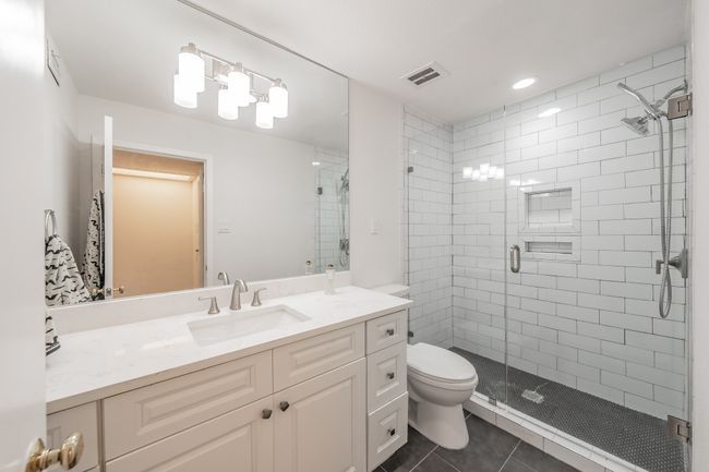 Full bath with visible vents, tile patterned floors, toilet, and a stall shower | Image 11
