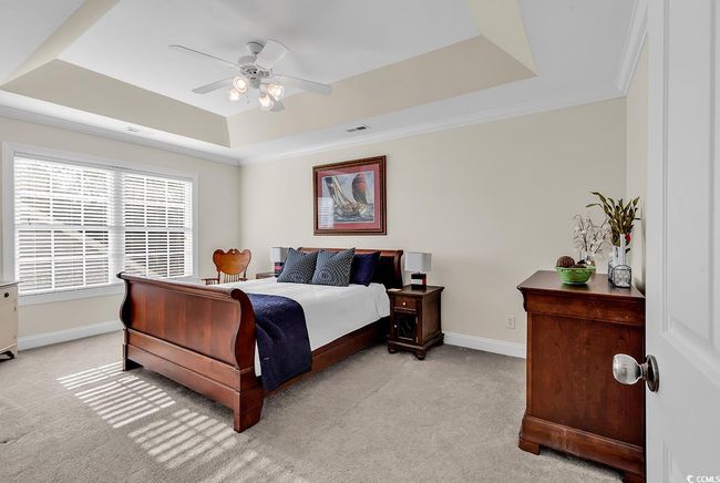 Bedroom featuring crown molding, ceiling fan, a raised ceiling, and a closet | Image 29