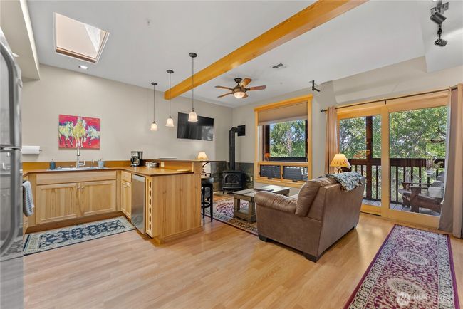 Open floor plan design with eat-in-kitchen, skylights, fully furnished. Everything in this unit comes with the property. | Image 21