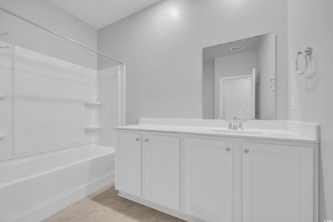 Bathroom featuring tile patterned flooring, visible vents, vanity, and bathing tub / shower combination | Image 13