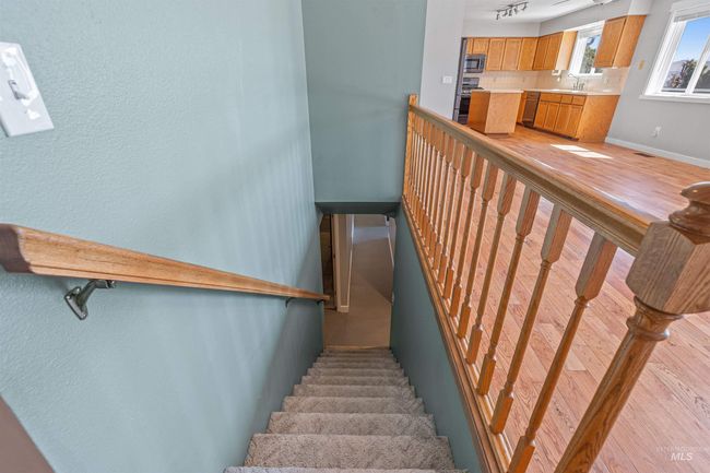 Stairway with baseboards and wood finished floors | Image 25