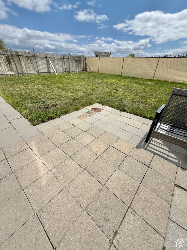 Fenced backyard with a patio | Image 14