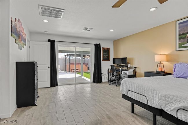 Bedroom featuring access to exterior, recessed lighting, visible vents, and light wood-type flooring | Image 13