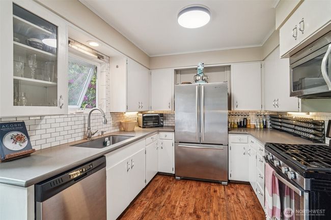 Modern high end appliances, gas stove, tile; yet charming vintage feel. | Image 11