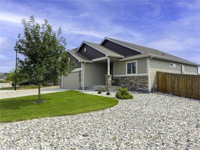 Craftsman-style home featuring a 2-car garage and a manicured front yard | Image 2