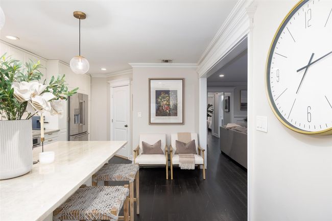 Living room featuring dark wood-style flooring, visible vents, baseboards, recessed lighting, and crown molding | Image 19