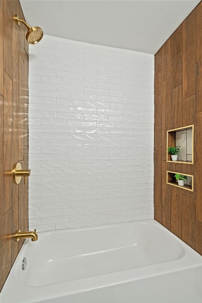 Bathroom featuring shower / bathtub combination | Image 19