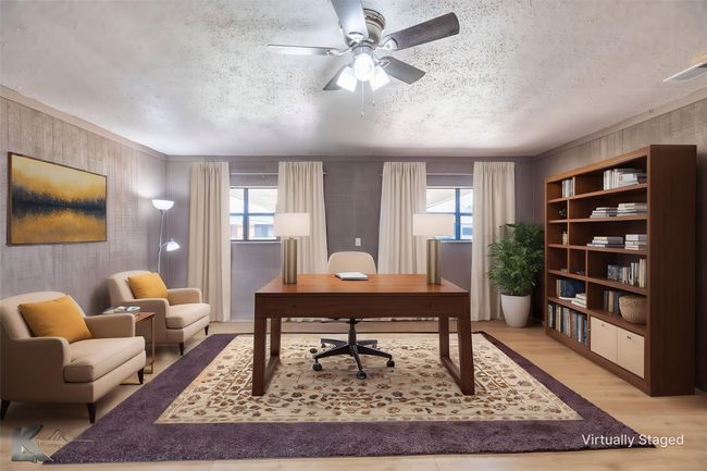 Home office with wallpapered walls, a textured ceiling, wood finished floors, a ceiling fan, and plenty of natural light | Image 5