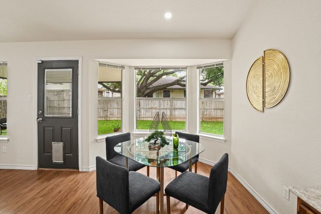 Bay windows fill the dining room with natural light and offer a peaceful view of the backyard. 9349 Bernoulli Dr., Austin, TX 78748 | Image 13