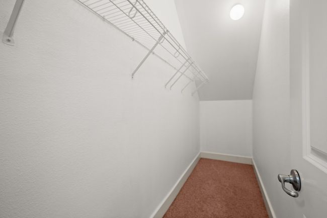 Walk in closet with light colored carpet and vaulted ceiling | Image 18