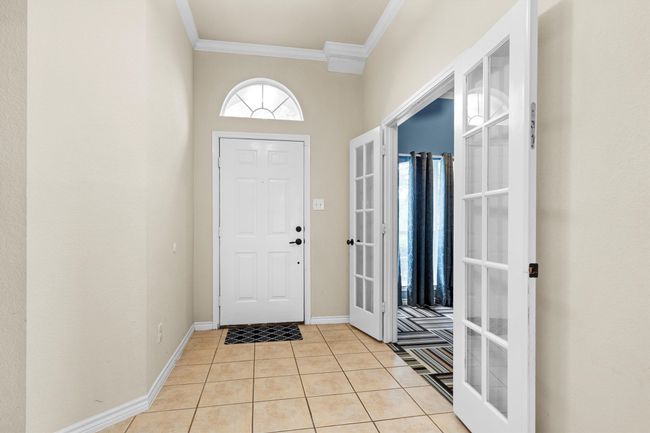 Foyer entrance featuring ornamental molding and light tile patterned floors | Image 5